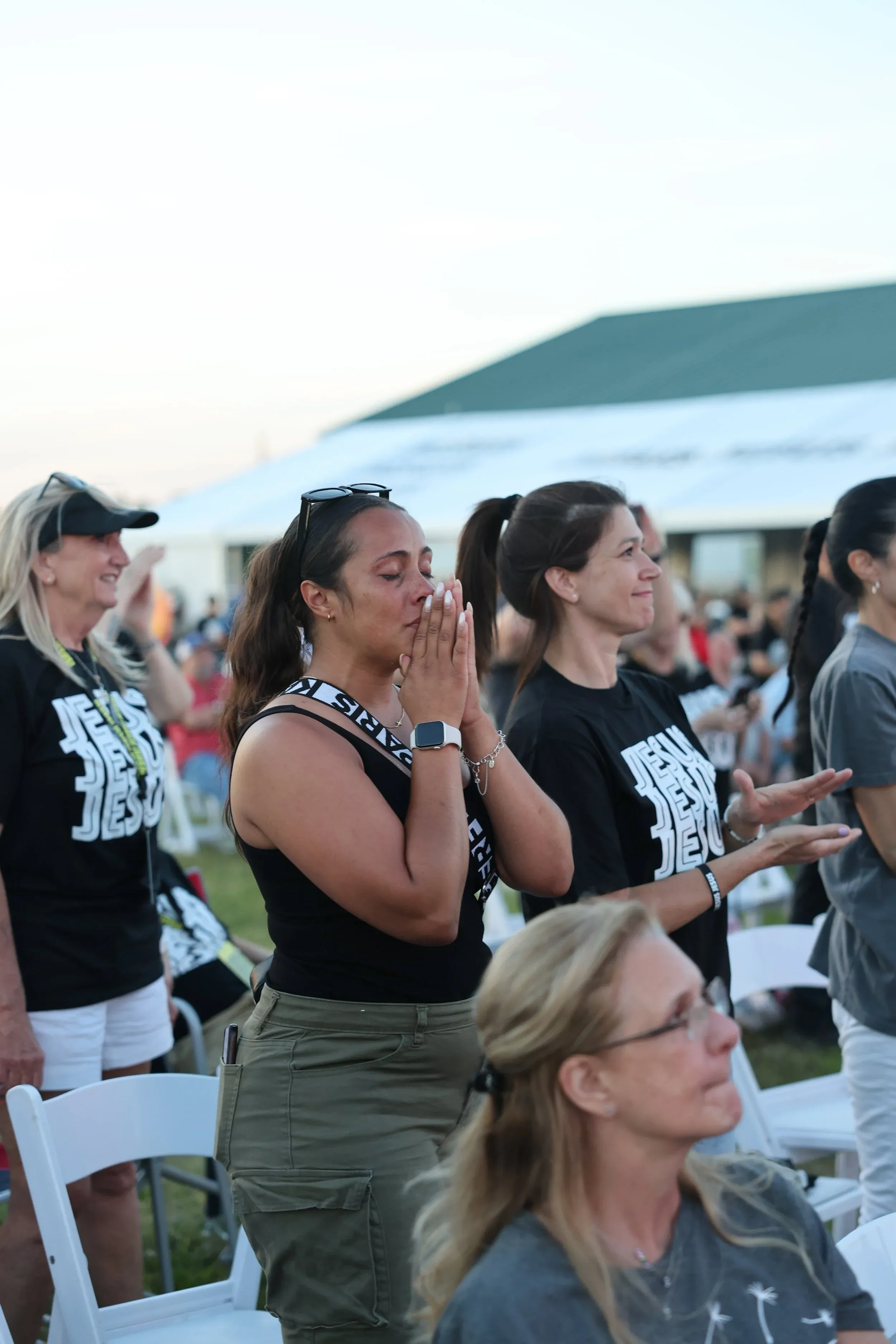 Women moved to tears during worship in the crowd